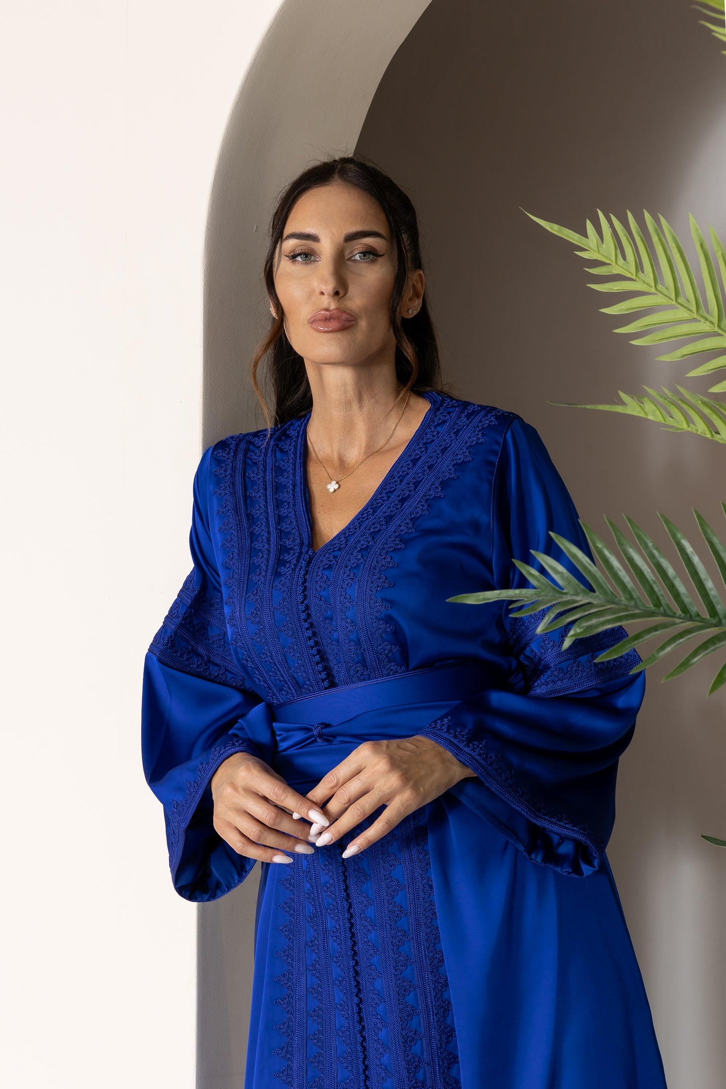Close-up of blue Moroccan kaftan with intricate neckline embroidery