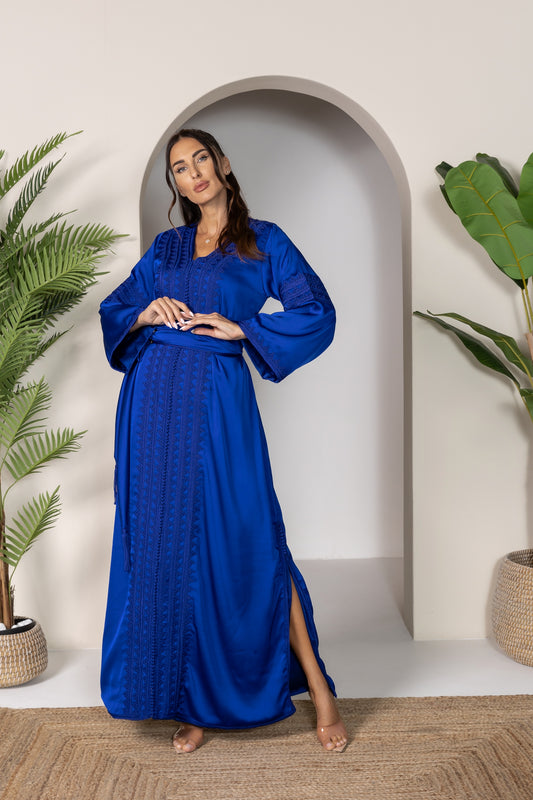 Woman in blue Moroccan kaftan with wide sleeves and a matching belt
