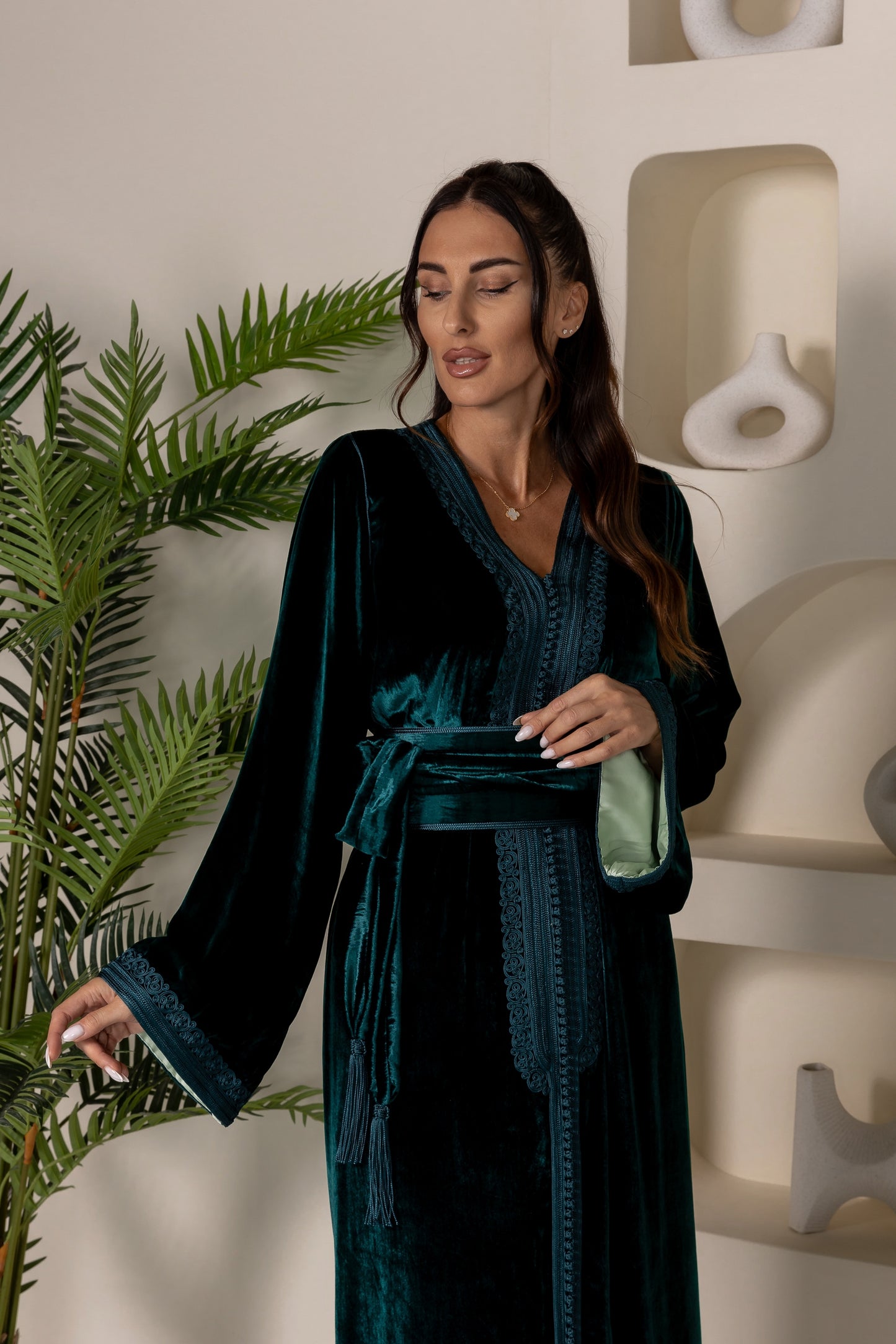 Close-up of green velvet Moroccan kaftan with intricate neckline embroidery